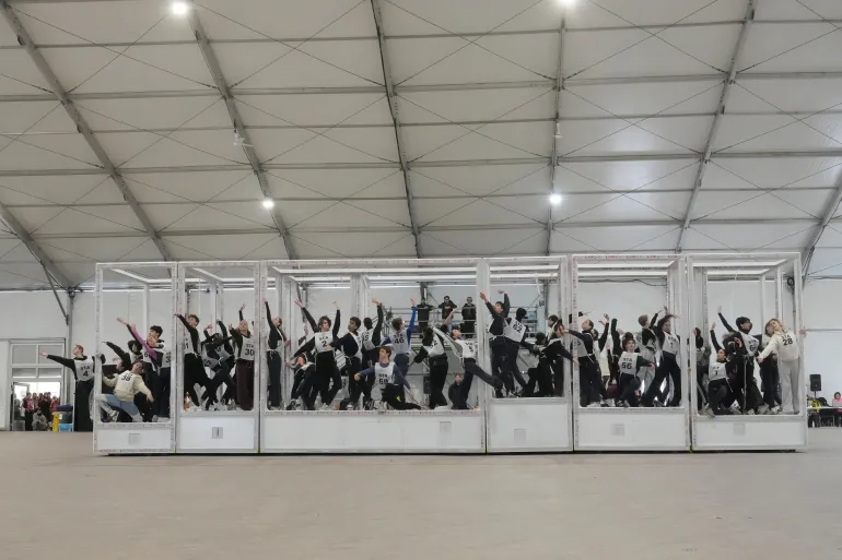 Volunteer dancers perform during rehearsals for the opening ceremony of the Milan Cortina 2026 Winter Olympic Games, at a compound in a big tent next to San Siro Stadium, in Milan, Italy, Saturday, Jan. 24, 2026. (AP Photo/Luca Bruno)