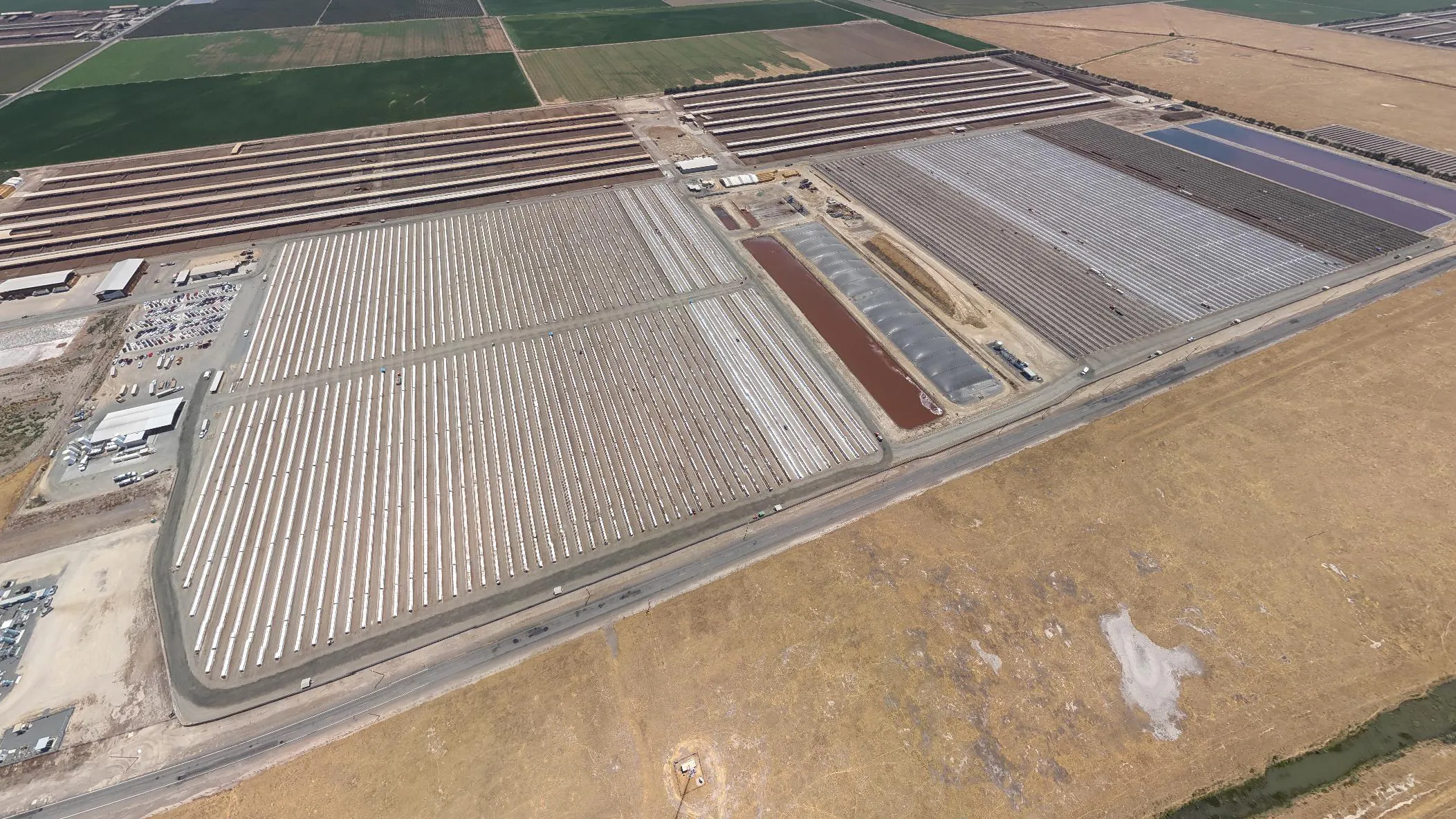 an aerial view of a massive dairy farm with rows of tightly-packed calves