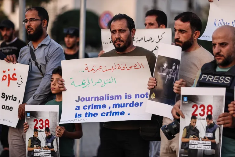Dozens of protesters, waving Palestinian flags and chanting slogans against Israel, protest Israel's attacks on Gaza in the Syrian capital Damascus, on August 11, 2025.