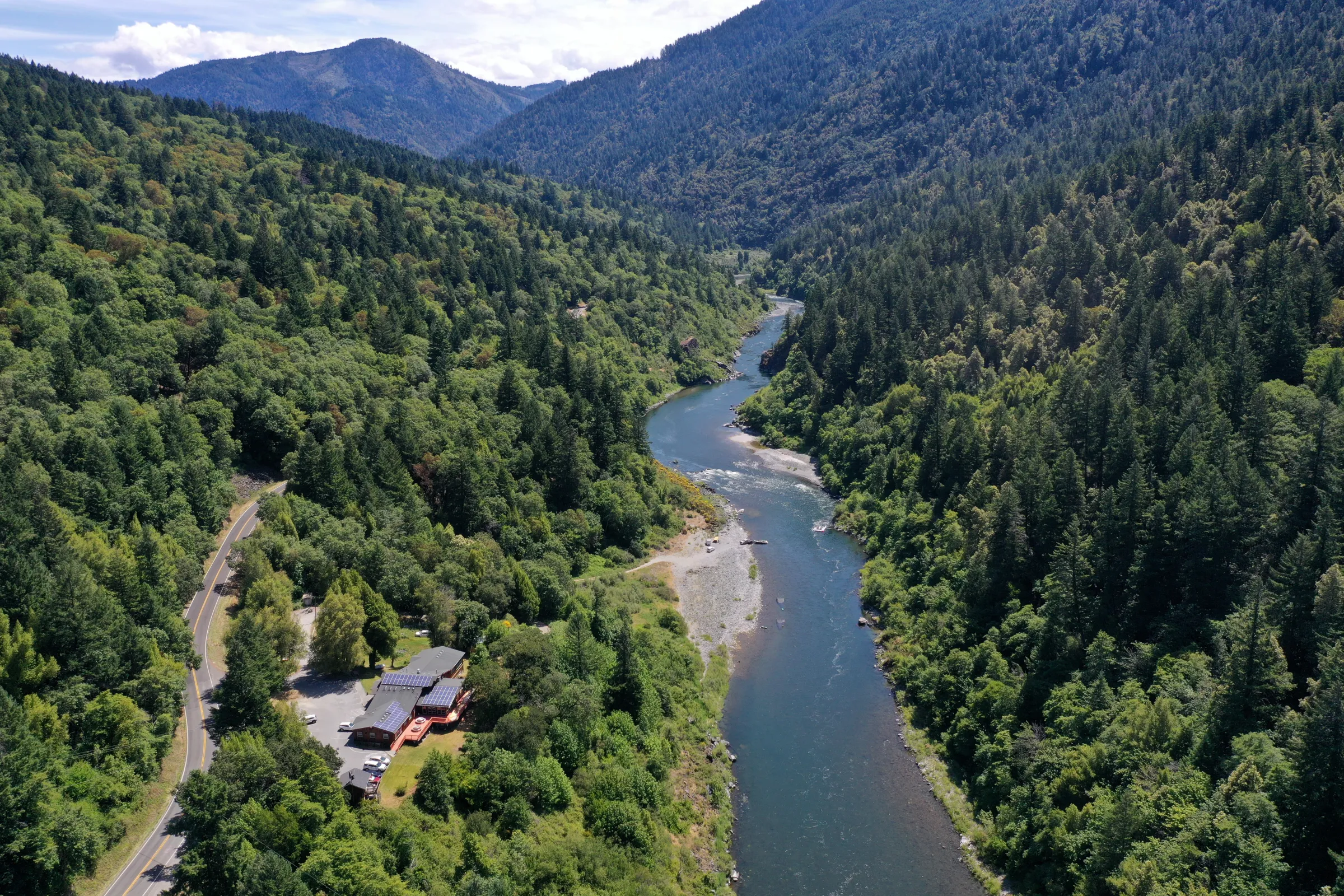 Aerial view of a river with lush greenery on both sides