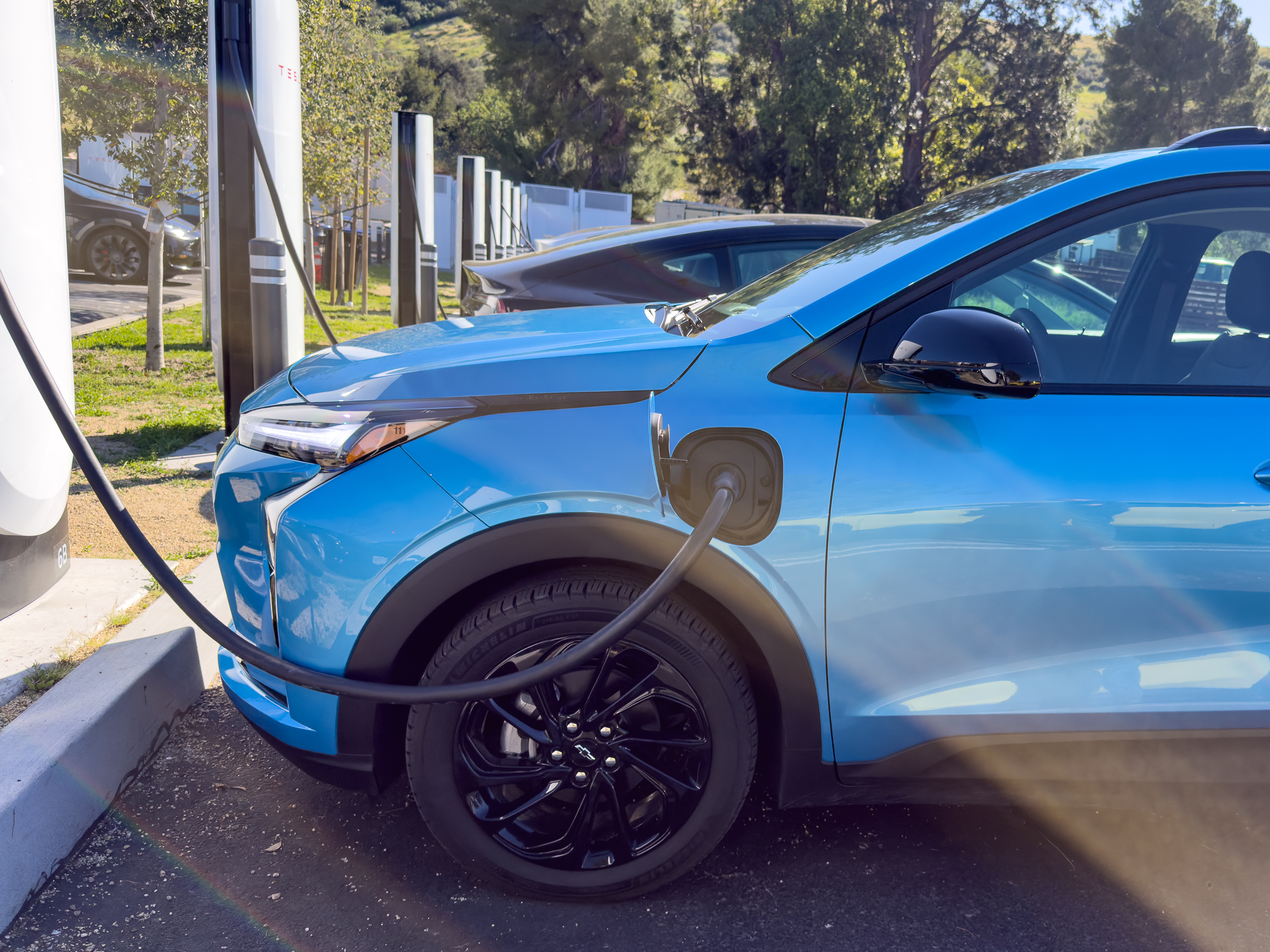 A blue Chevy Bolt charges