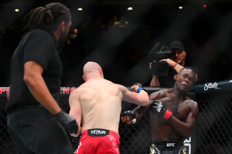 Joe Pyfer and Israel Adesanya in action.