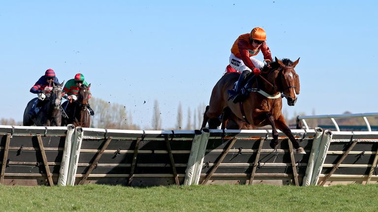 Charisma Cat ridden by Thomas Bellamy jump the hurdle on their way to winning at Newbury