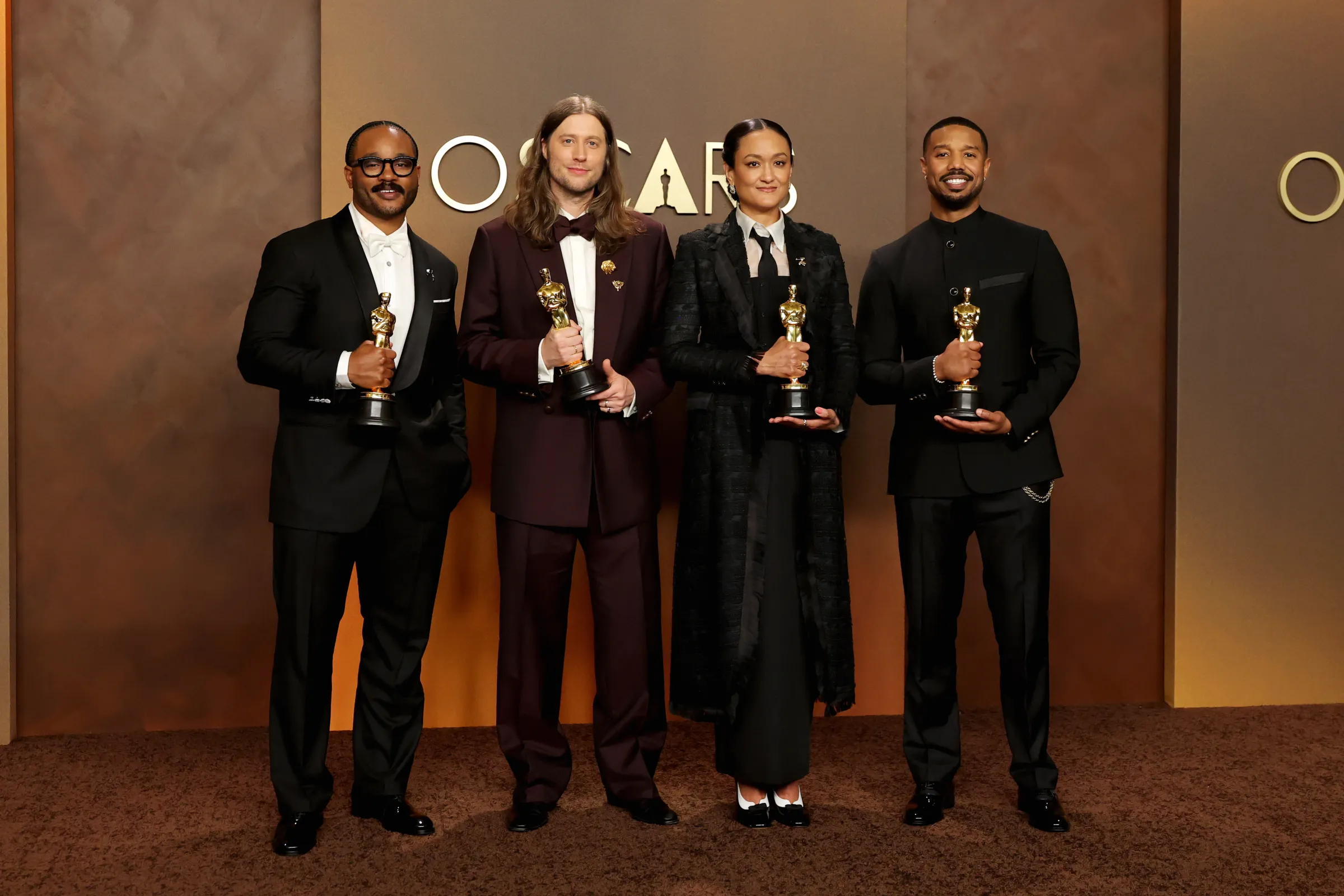Ryan Coogler, Ludwig Göransson, Autumn Cheyenne Durald Arkapaw, and Michael B. Jordan with their Oscar statues.