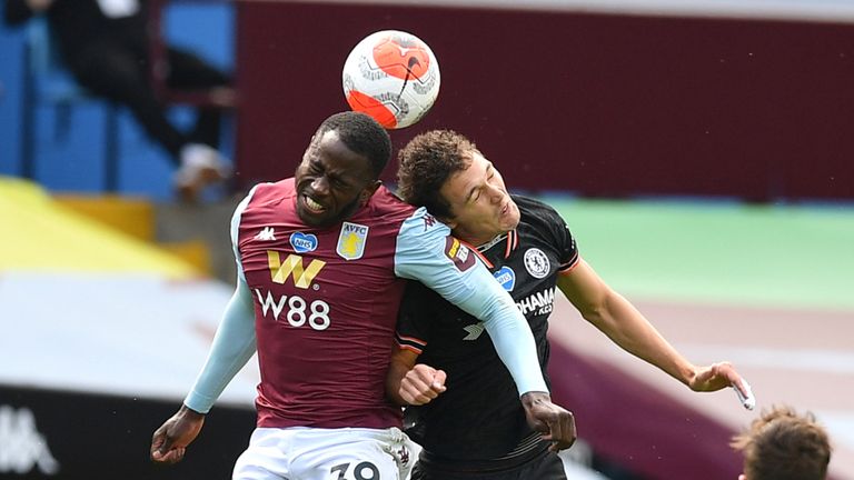 Keinan Davis of Aston Villa battles for possession with in the air with Andreas Christensen of Chelsea