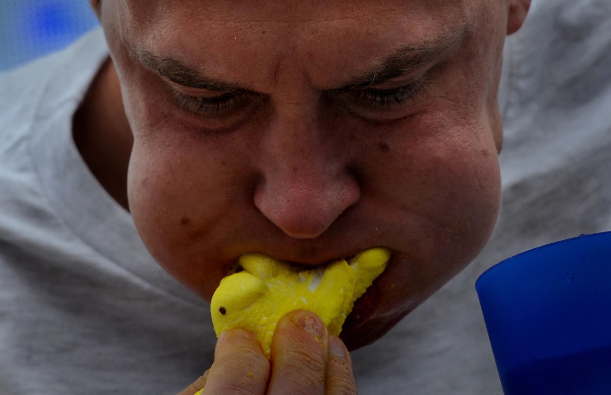 Man eating a yellow Peeps