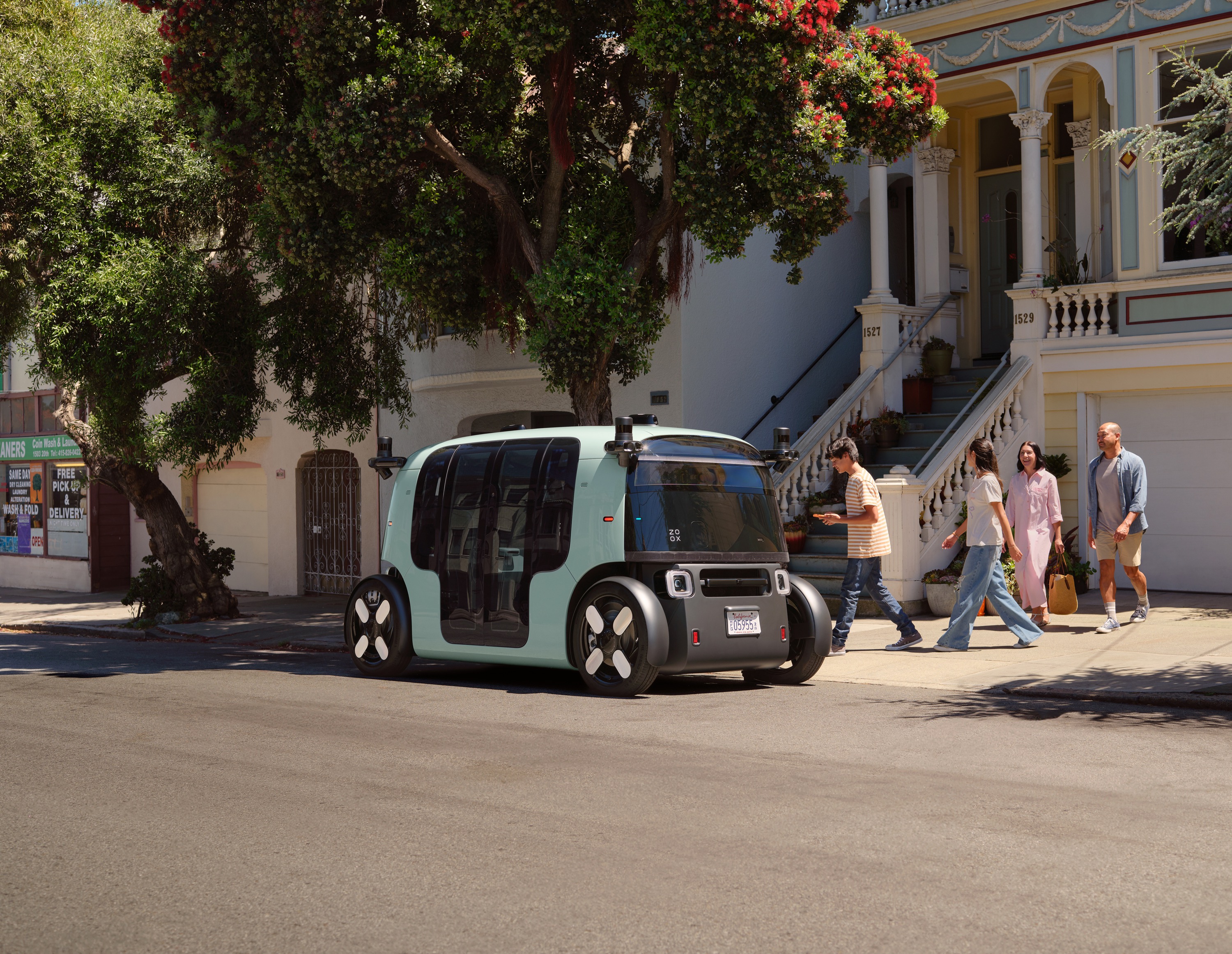 A Zoox robotaxi picks up riders