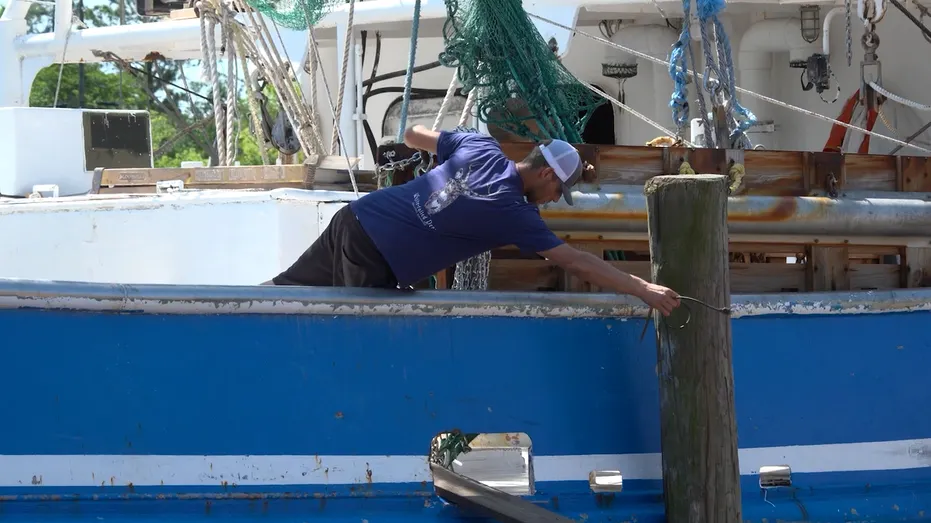 American shrimper works on shrimp boat