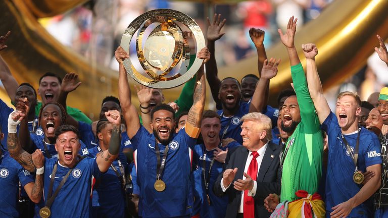 USA President Donald Trump looks on as Chelsea captain Reece James lifts the Club World Cup