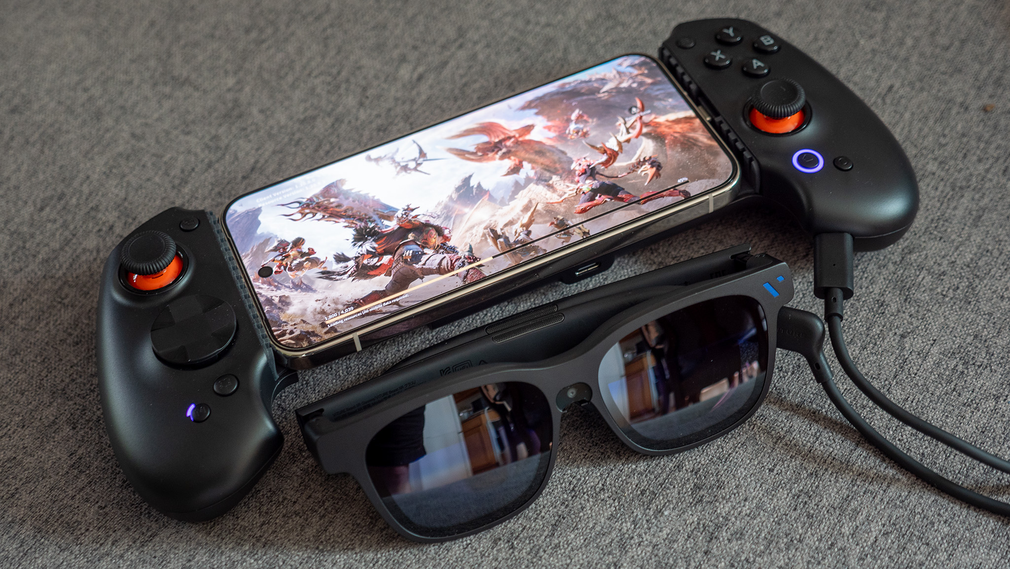 Viture Beast smart glasses connected to an Abxylute S9V controller, with Monster Hunter Outlanders playing on a Google Pixel 10 Pro XL