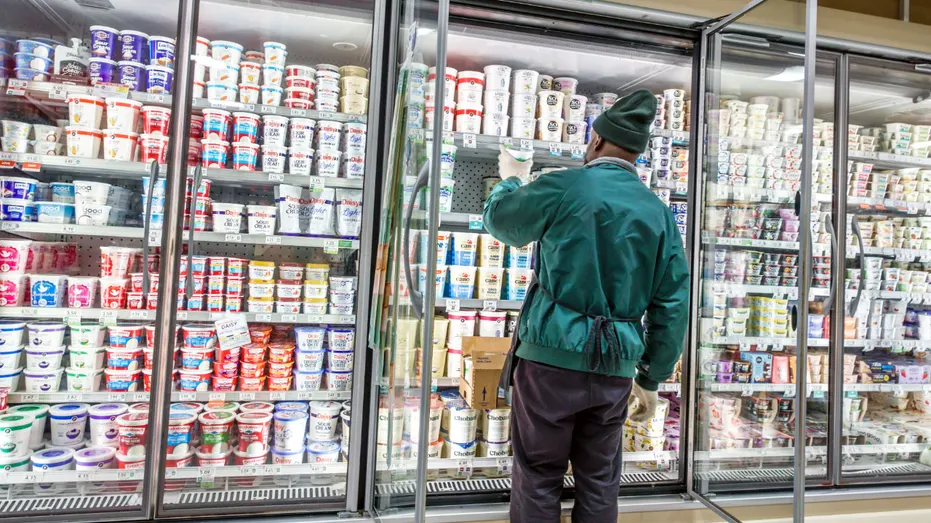 Publix employee in front of the dairy section.