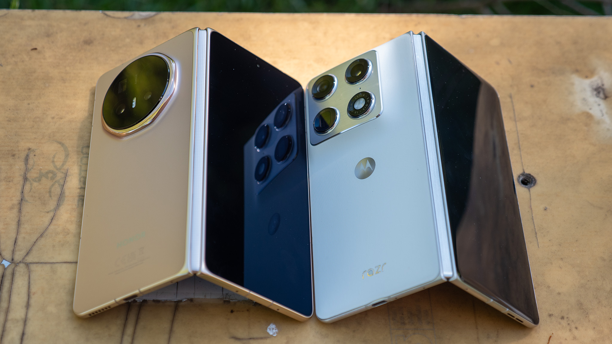Comparing the gold Honor Magic V6 with the white Motorola Razr Fold 2026