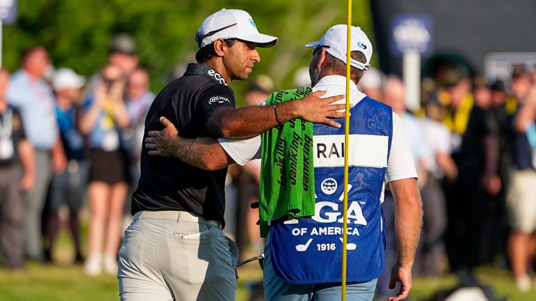 Aaron Rai, of England, hugs his caddie after his round on the 18th green during the final round of the PGA Championship 