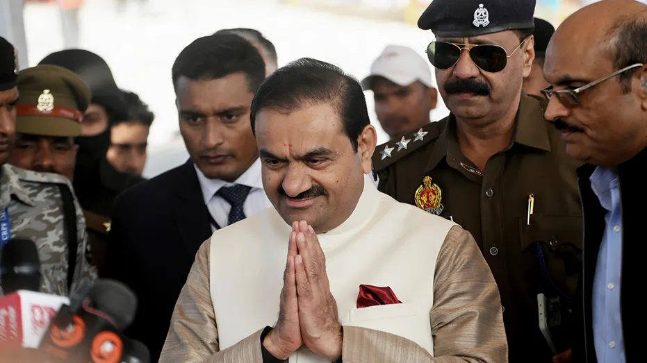 Gautam Adani portrays a prayer stance during a festival
