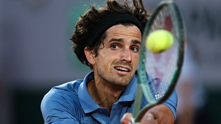 France's Pierre-Hugues Herbert plays a backhand return to Italy's Lorenzo Sonego during their men's singles match on day 1 of the French Ope
