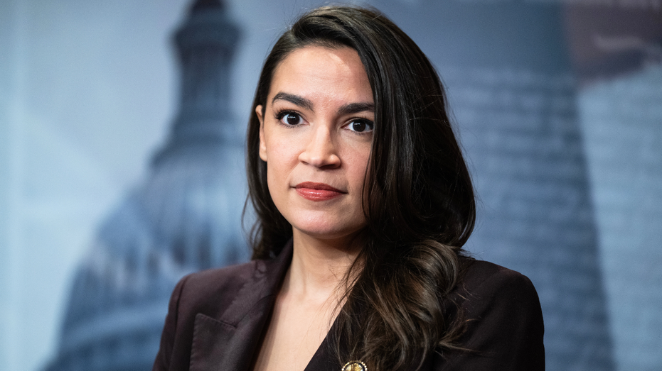 NY Rep. Alexandria Ocasio-Cortez listens to a question during a news conference.