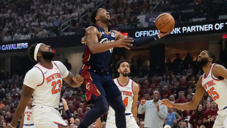 Cleveland Cavaliers guard Donovan Mitchell (45) shoots against New York Knicks center Mitchell Robinson (23)