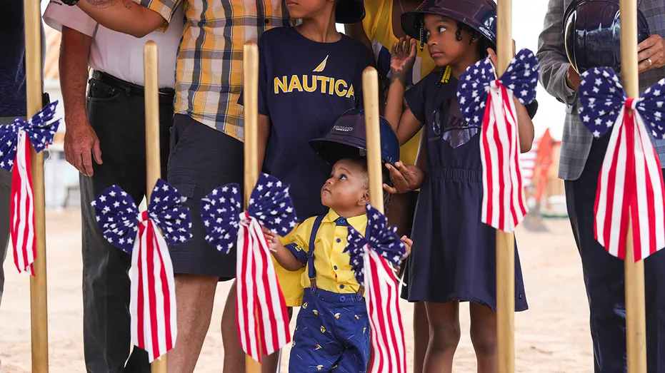 Child looks up as military family gifted mortgage-free home