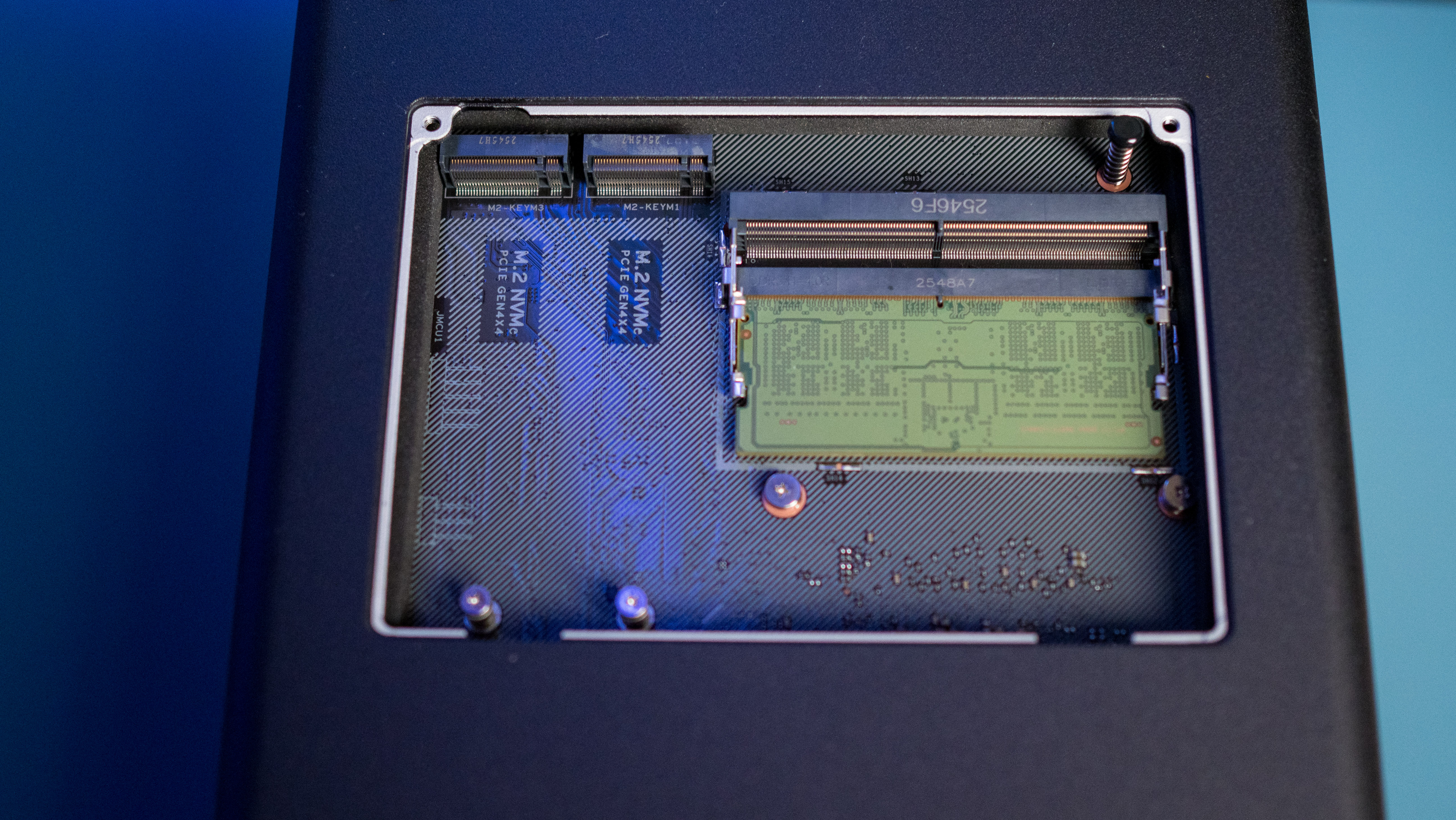 UGREEN DXP4800 Pro 4-bay NAS on a side table highlighting the M.2 slots and memory modules at the bottom side