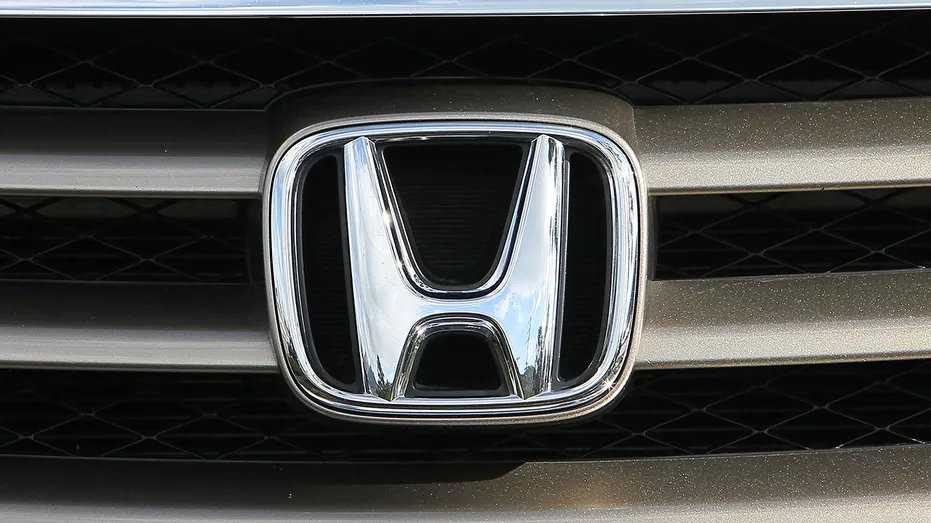 The Honda logo is seen on the grill of a Honda mini van