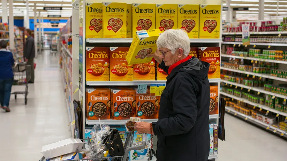 shopper picks up cheerios