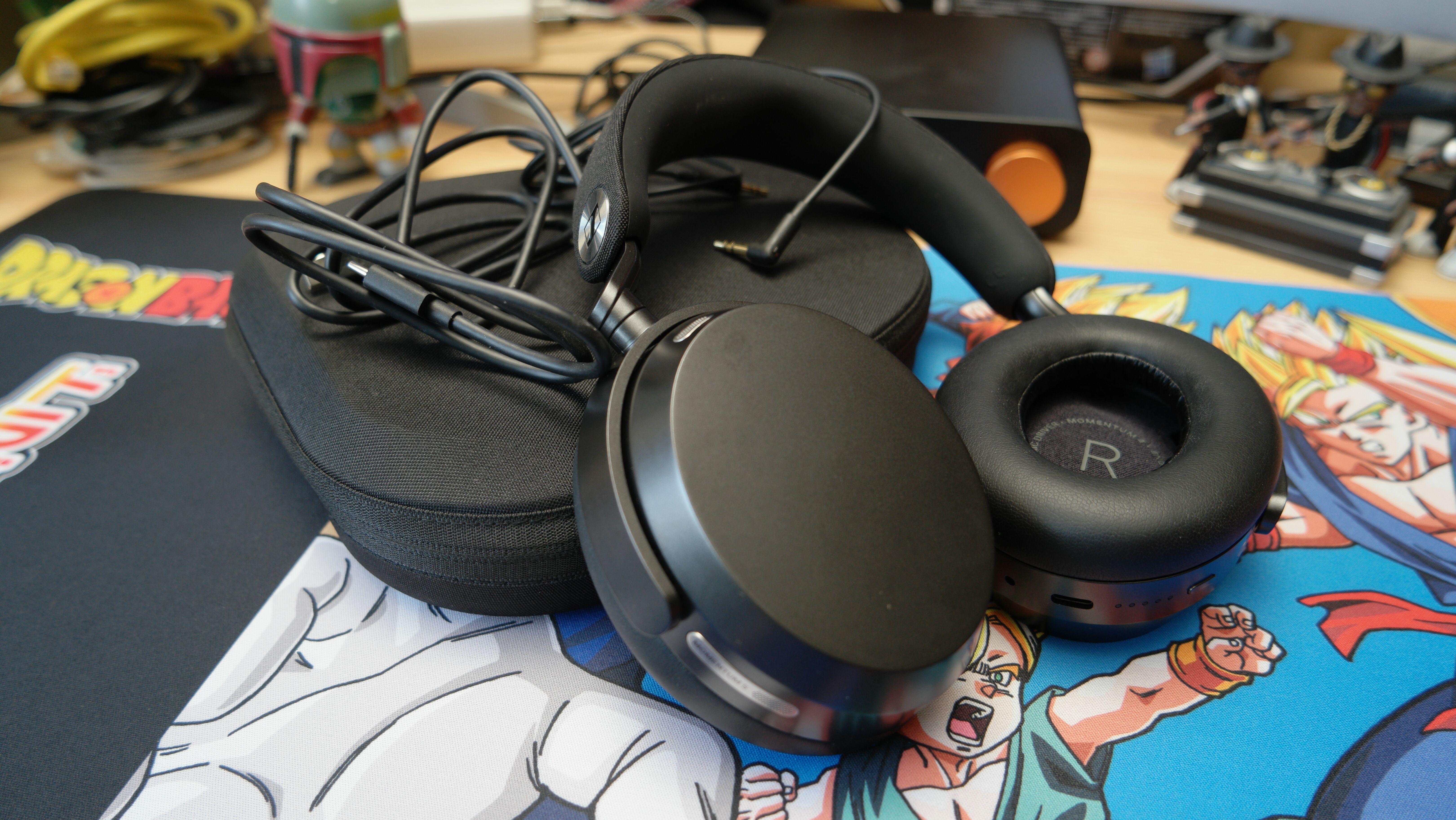 Sennheiser Momentum 5 headphones on a desk with everything that comes in the box