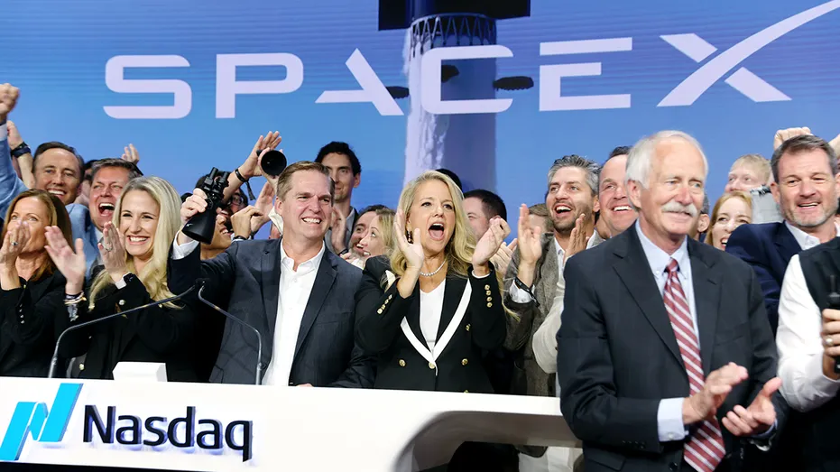 SpaceX executives ring the opening bell at the Nasdaq.