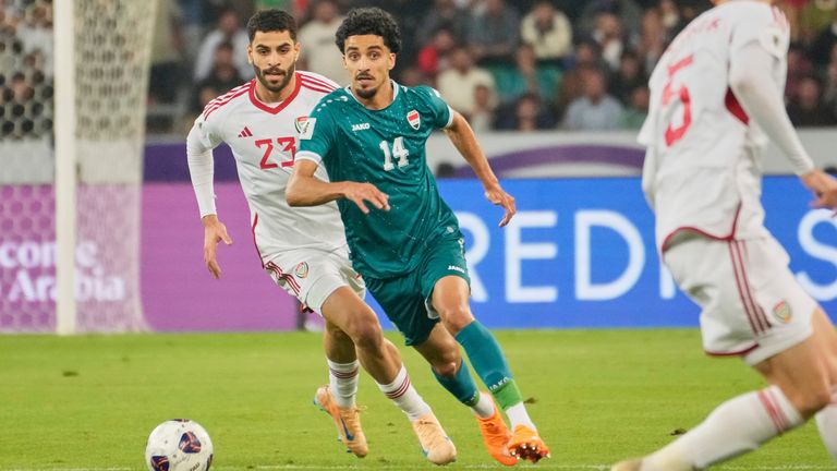 Iraqi's Zidane Iqbal, center, fights for the ball during the 2026 World Cup play off second leg soccer match between UAE and Iraq