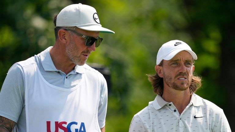 Tommy Fleetwood, of England, waits on the 13th tee box with his caddie, Ian Finnis, left, during the first round of the U.S. Open golf 