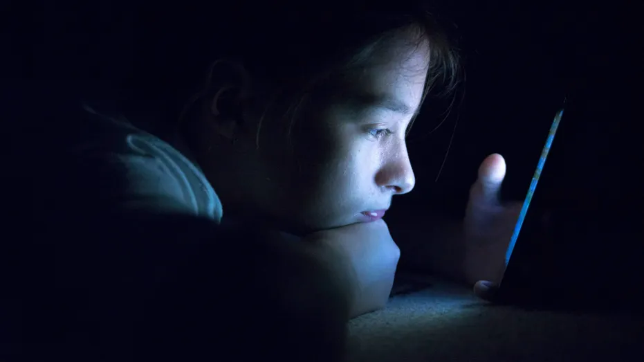 Kid on mobile phone.