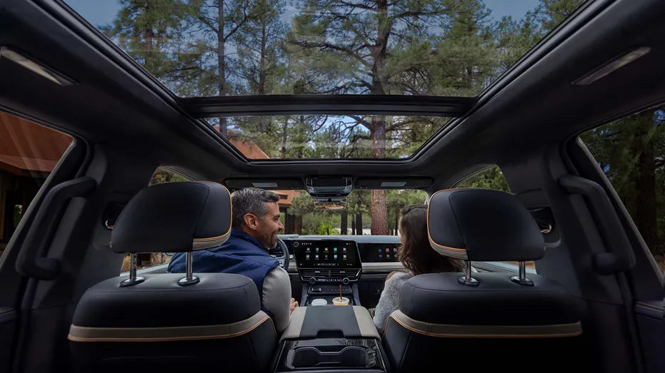 The second-row interior of a 2027 Chevrolet Silverado 1500 High Country features Enoki trim and a panoramic sunroof.