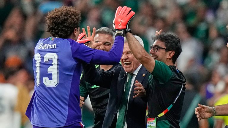 Ochoa celebrates with Mexico head coach Javier Aguirre after the third goal