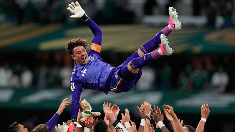 Mexico goalkeeper Guillermo Ochoa is thrown in the air by his team-mates