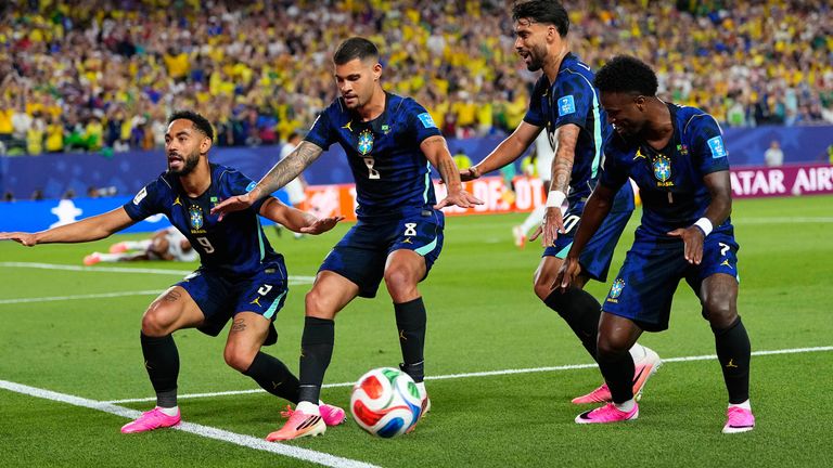Brazil's Matheus Cunha (9) celebrates after scoring his side's opening goal with teammates during the World Cup Gro