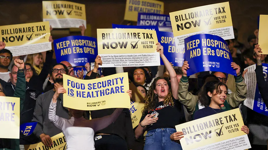 Protesters hold signs in support of billionaire tax