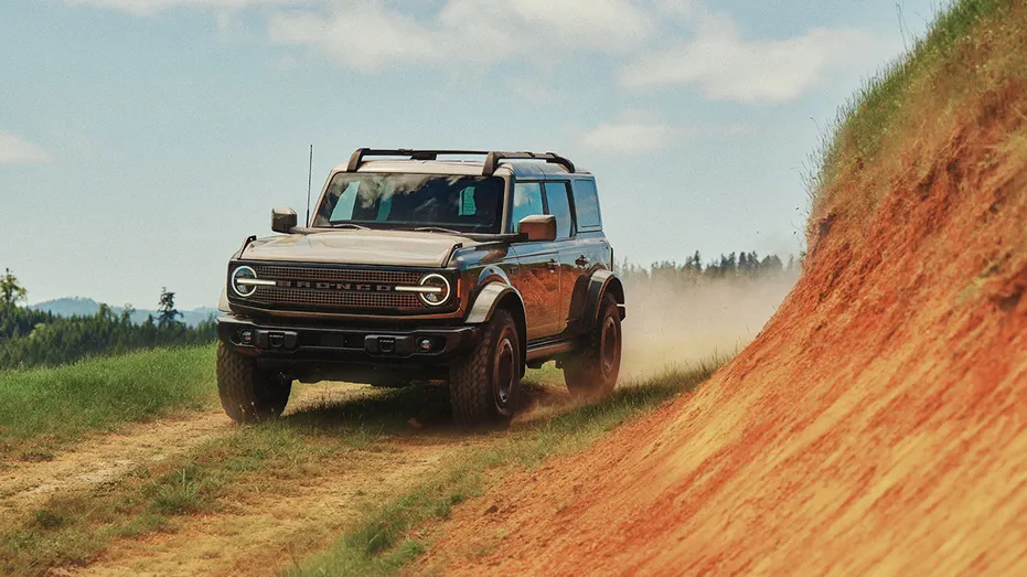 The 2027 Ford Bronco Filson drives along a dirt trail.