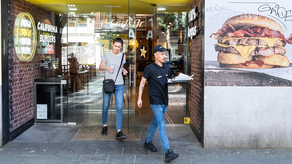 customer walks out of fast food location