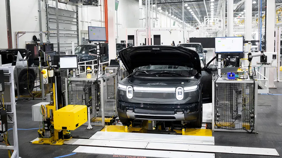 A Rivian R2 undergoing inspection on the assembly line