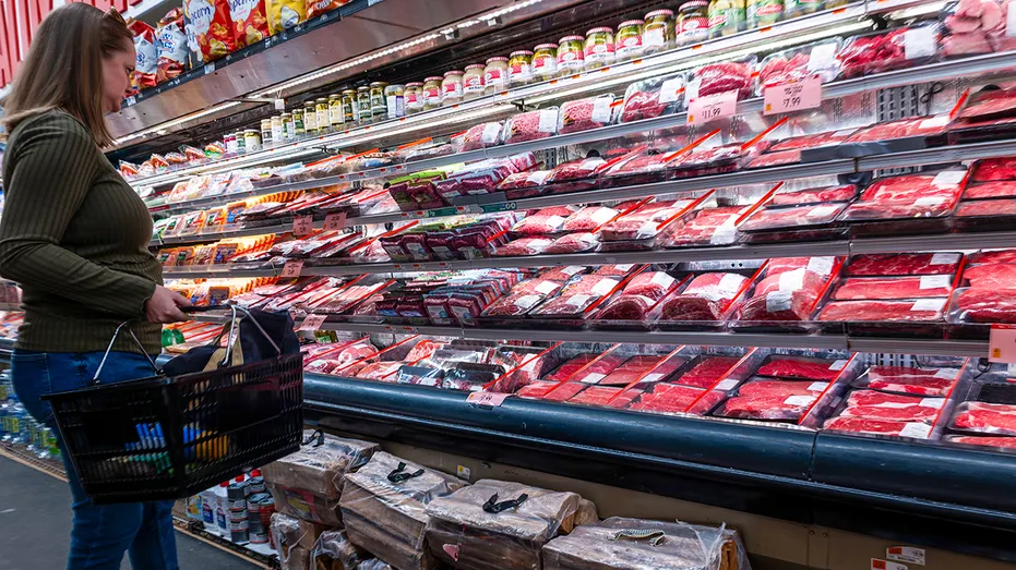 Woman shops for meat at grocery store