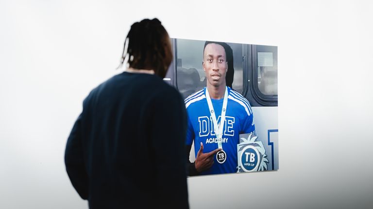 Yan Diomande looks at a photo from his time at the DME Academy [Credit: RB Leipzig]