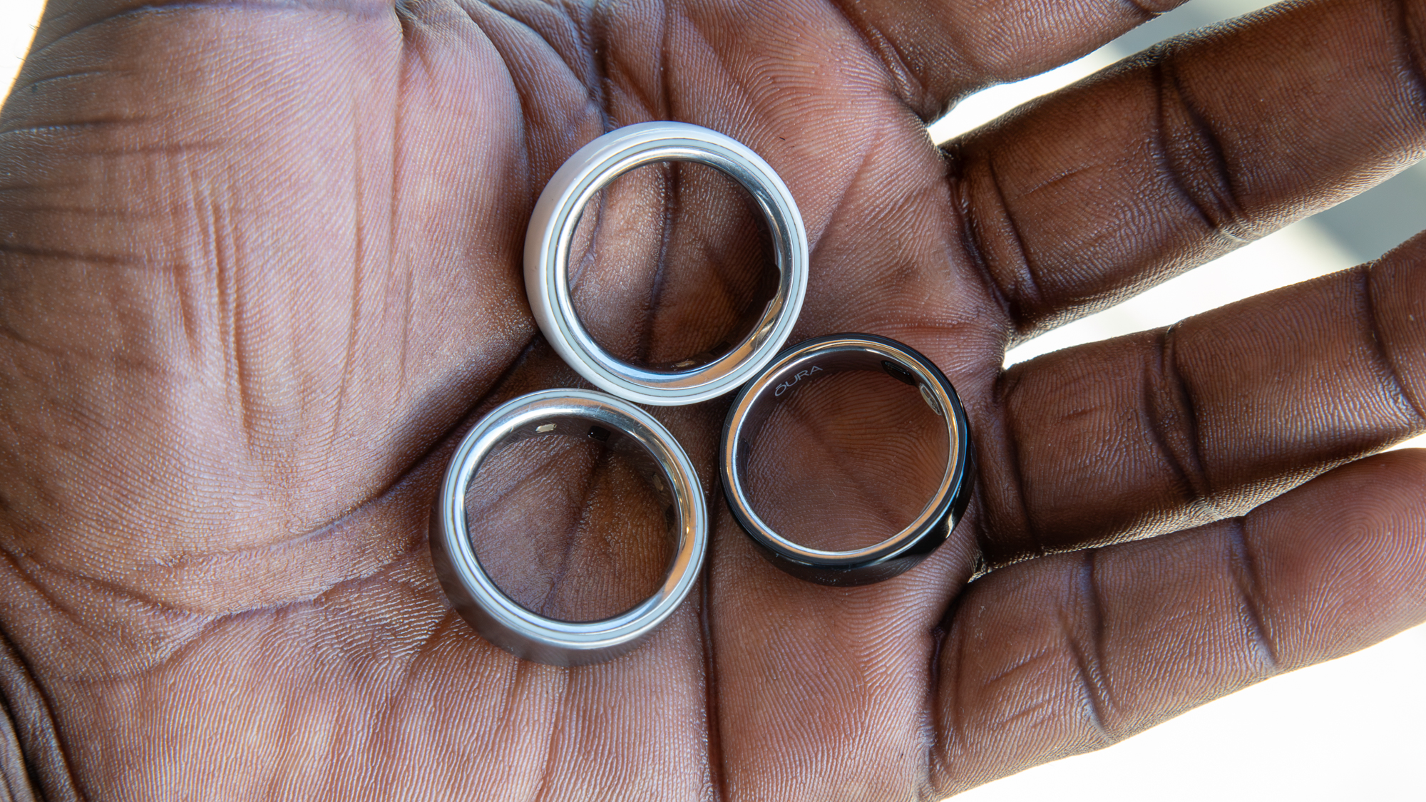 Oura Ring 5 next to the Oura Ring 4 and Oura Ring 4 Ceramic