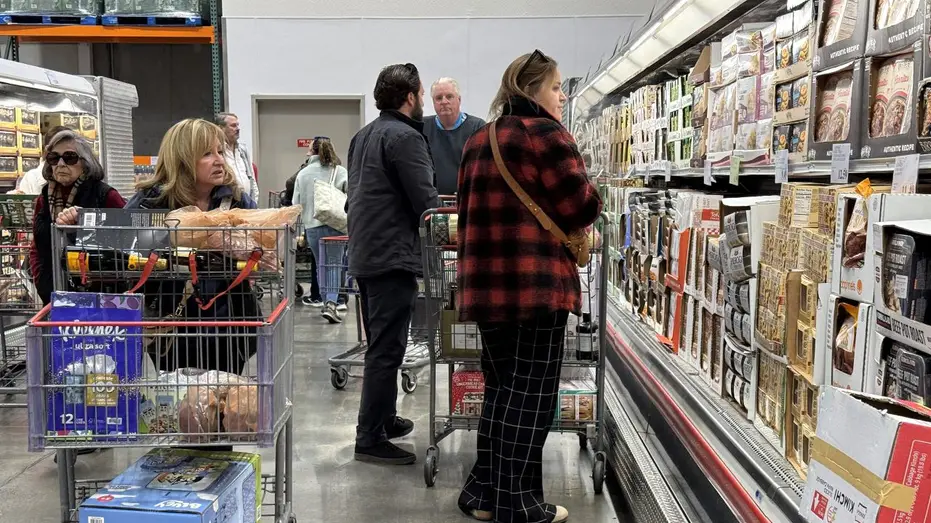 Shoppers looking at grocery prices