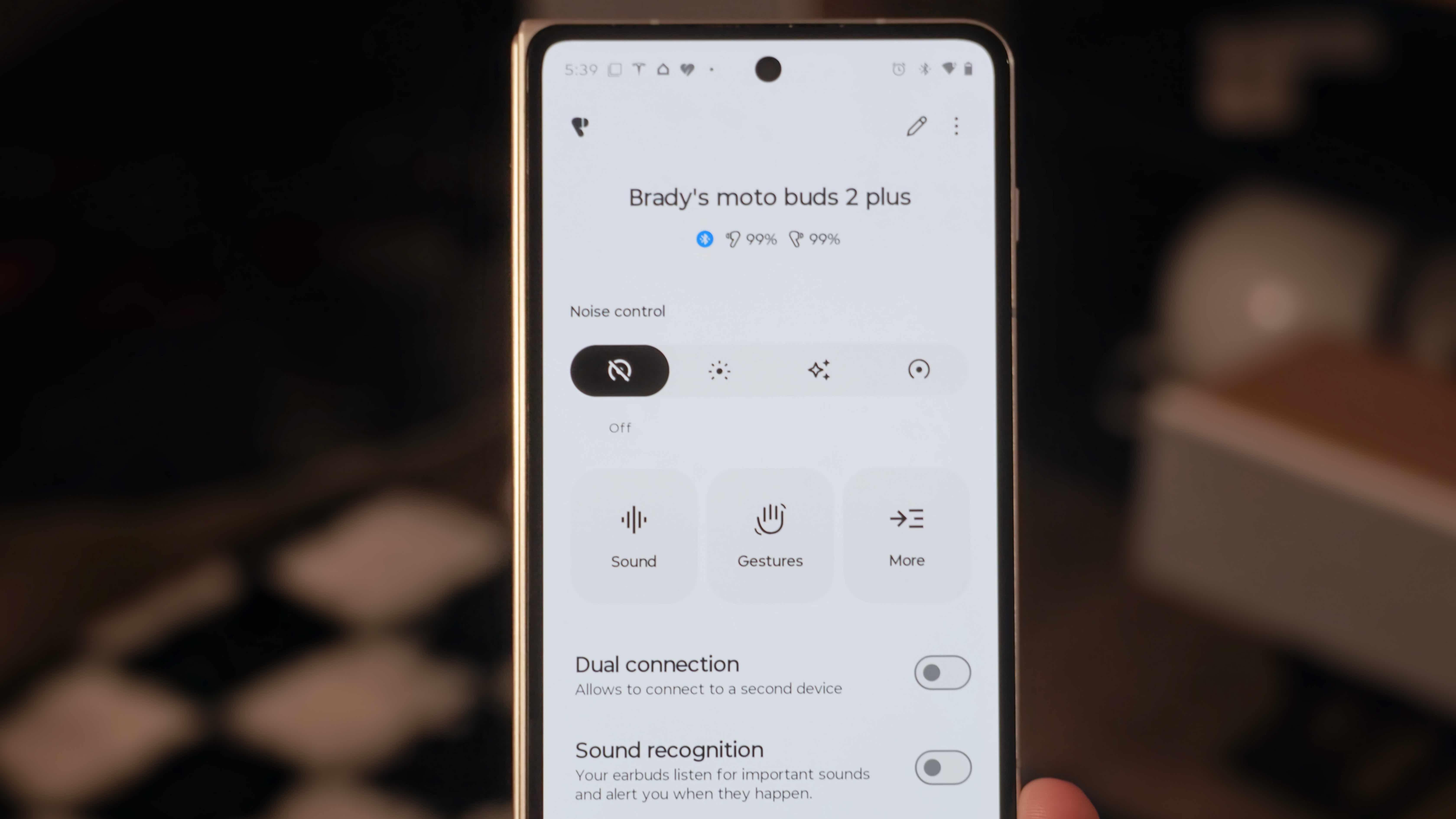 The Moto Buds 2 Plus alongside their companion app showing settings to change to improve audio quality.