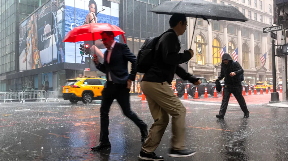 people walk in nyc during rain