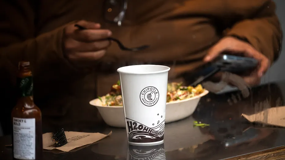 A customer dines inside a Chipotle restaurant