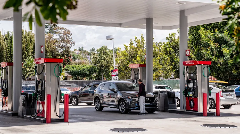 A man getting fuel at a gas station