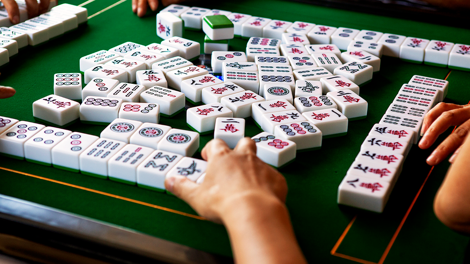 A popular Chinese game, Mahjong, being played.