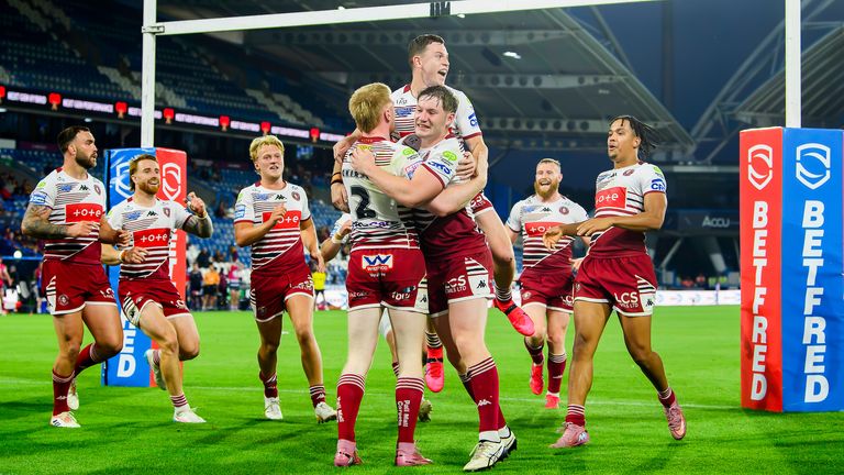  Wigan celebrate Zach Eckersley's hat-trick try against Huddersfield