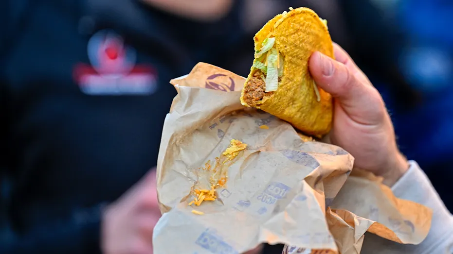 Person holds Taco Bell taco