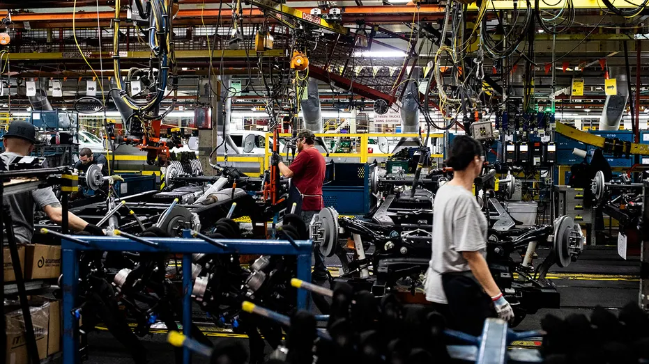 Workers at a GM auto assembly plant